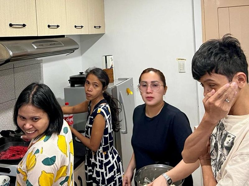 TrustBridge team members cooking together.