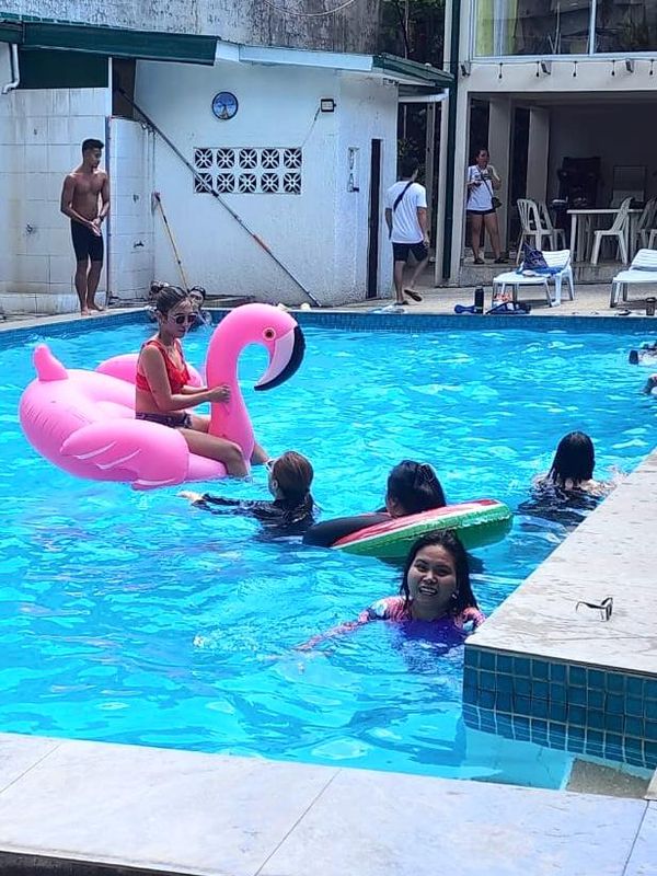 TrustBridge team members at the pool during a retreat.